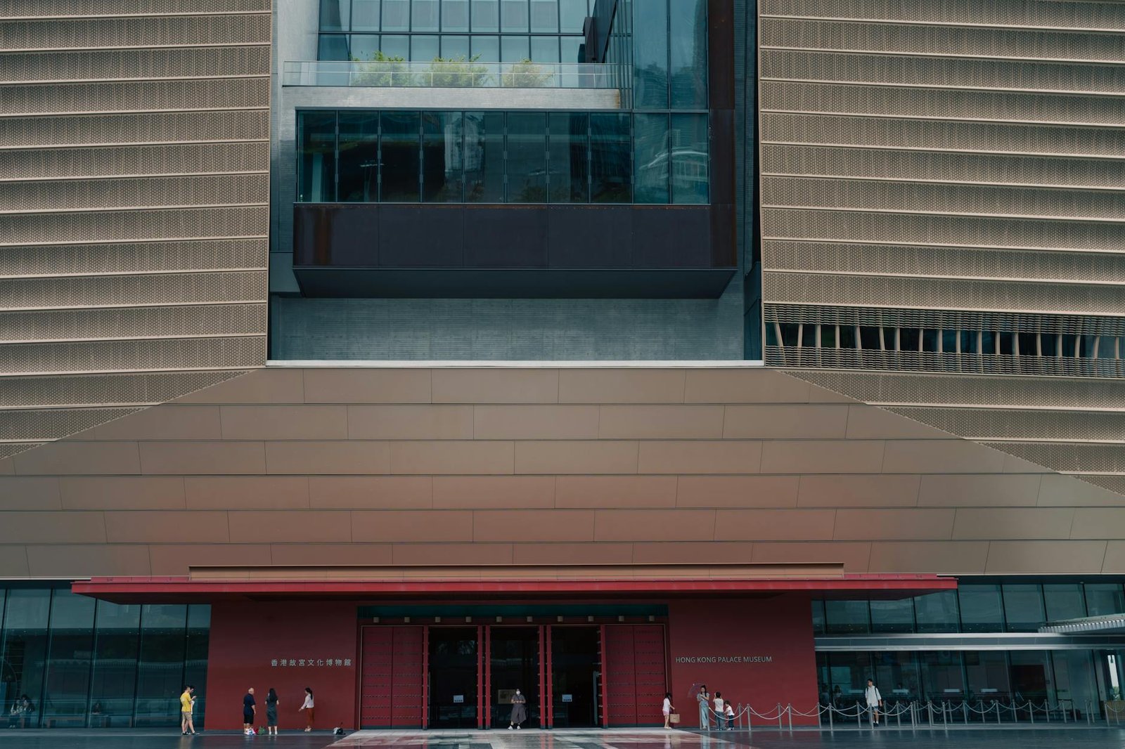 Front view of the Hong Kong Palace Museum showcasing its modern design and visitors.