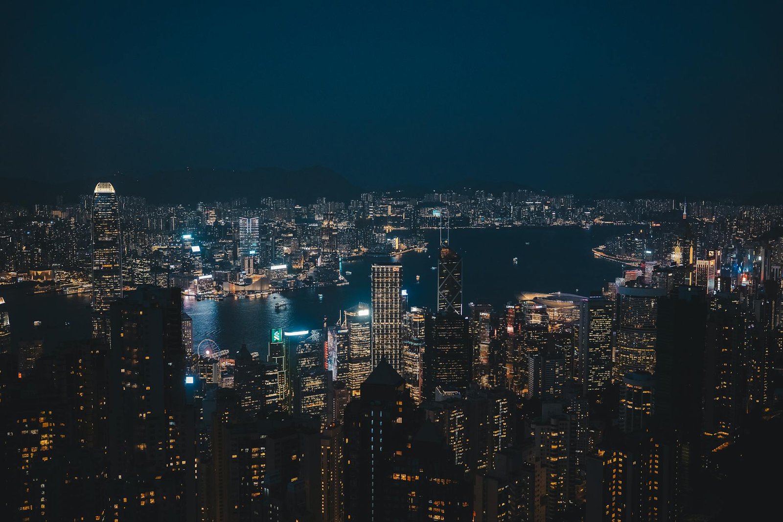Breathtaking night cityscape of Hong Kong Island's vibrant skyline overlooking the harbor.