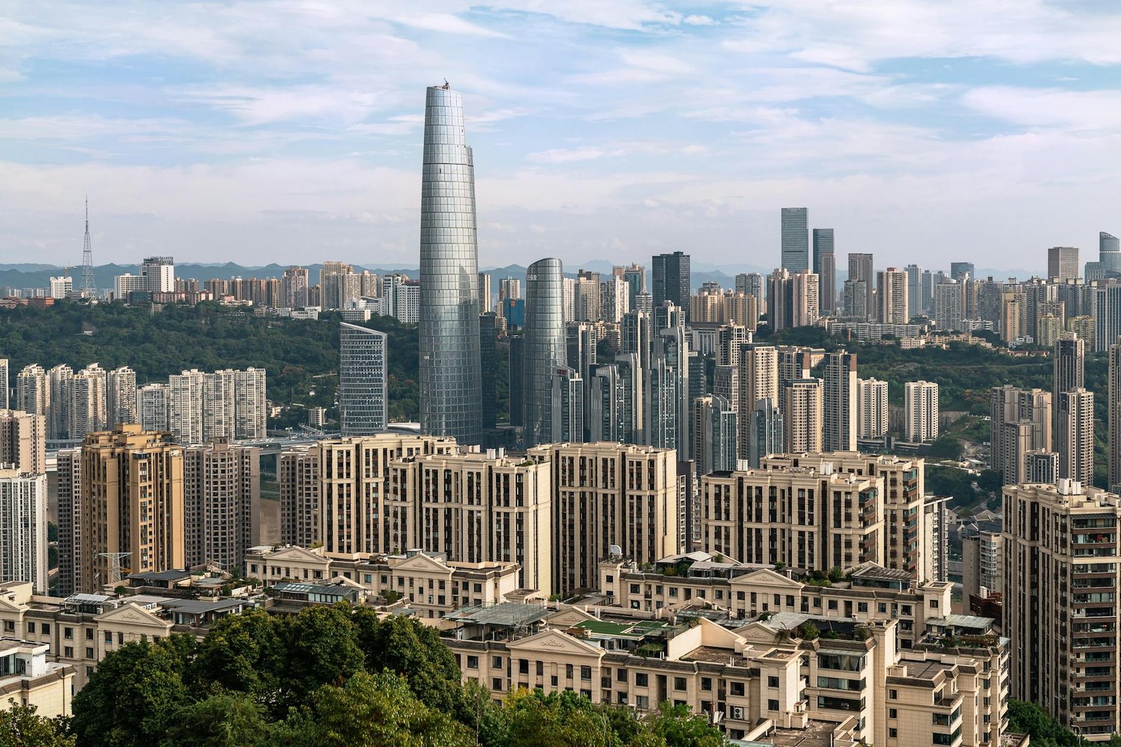 A dynamic cityscape showcasing tall skyscrapers under a clear sky, highlighting urban architecture.