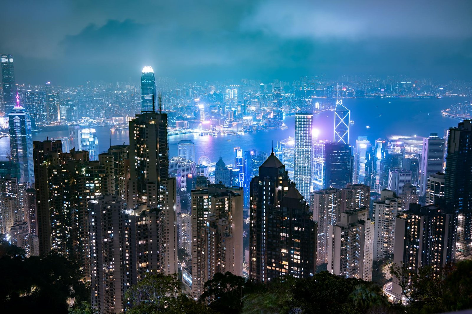 Captivating night view of Hong Kong's skyline, showcasing illuminated skyscrapers and Victoria Harbour.