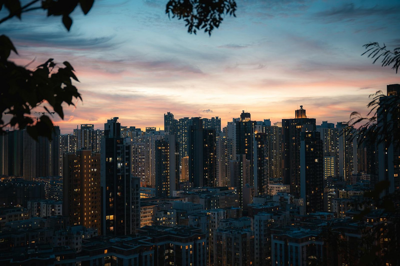 Stunning view of Hong Kong's skyline at dusk, highlighting skyscrapers against a vibrant sunset.