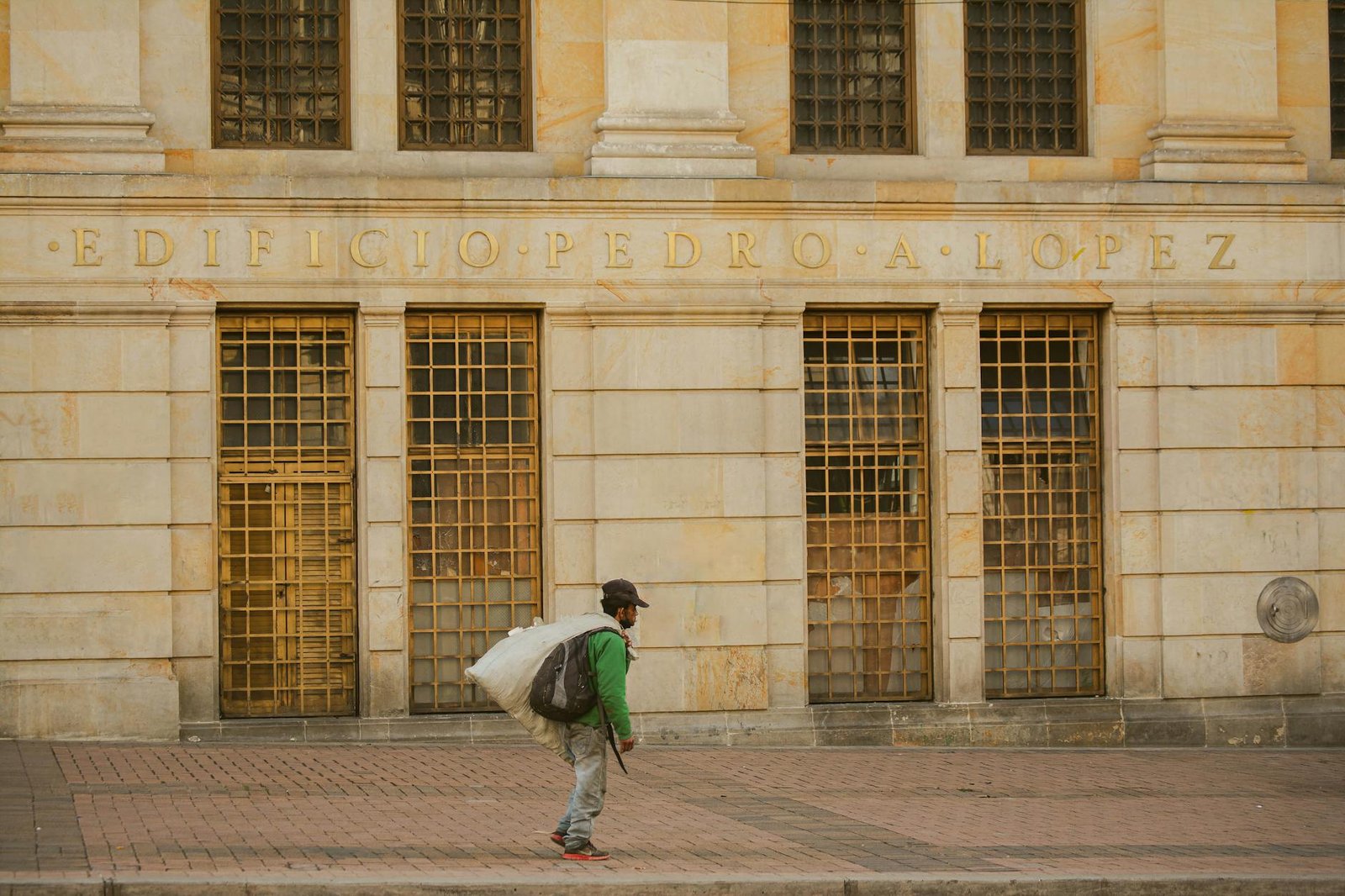 Man walking past Edificio Pedro A. Lopez in Bogotá, Colombia.