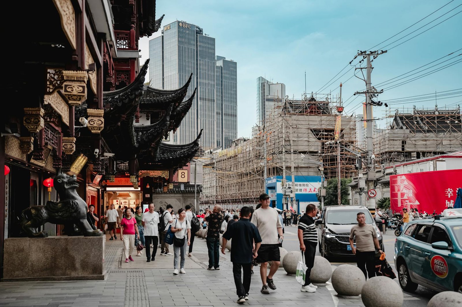 A bustling urban street scene blending modern skyscrapers and traditional Asian architecture.