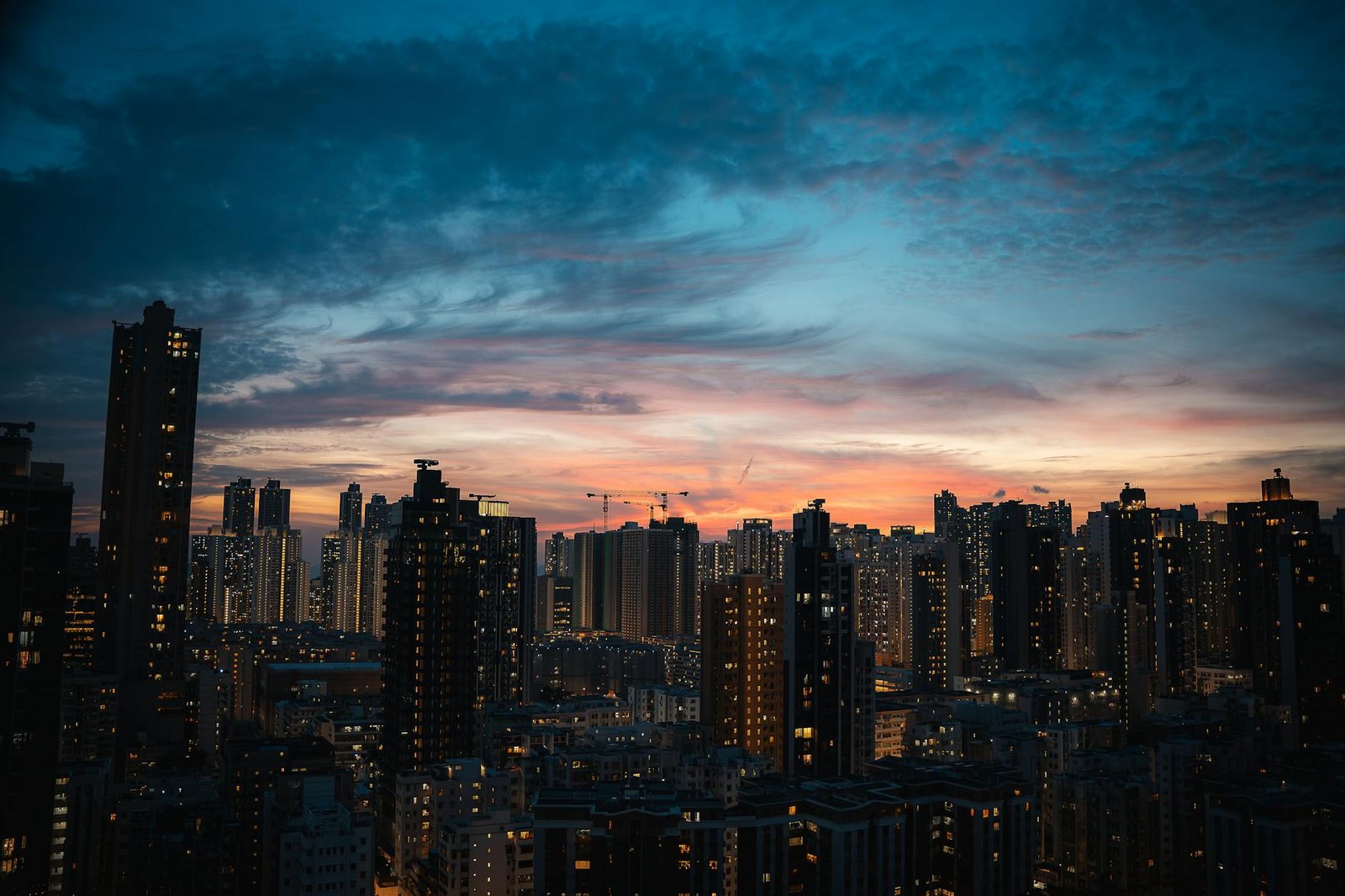Breathtaking view of Hong Kong skyscrapers silhouetted against a vibrant twilight sky.