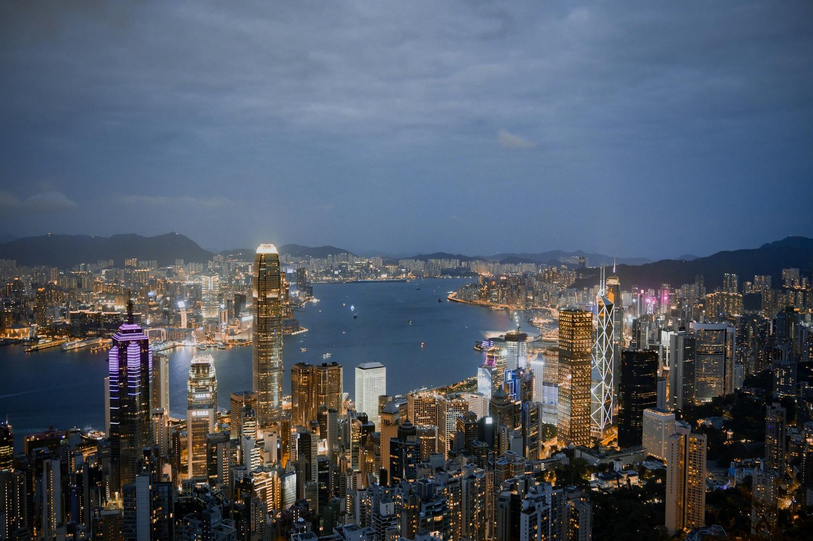 A breathtaking view of Hong Kong's illuminated skyline and harbor at night.