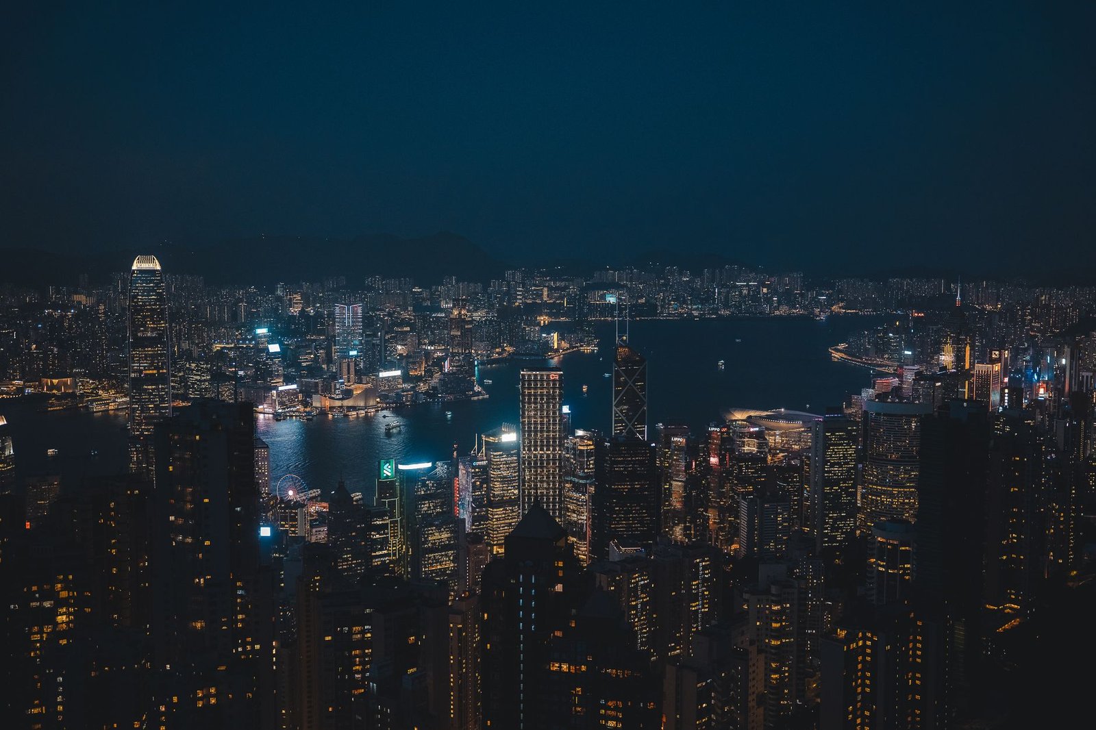 Breathtaking night cityscape of Hong Kong Island's vibrant skyline overlooking the harbor.
